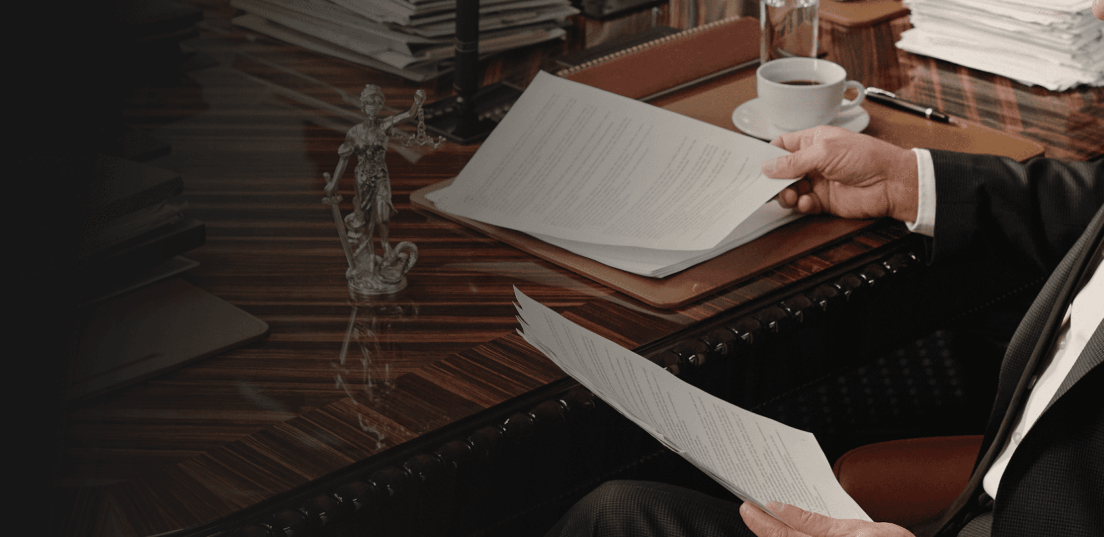 Attorney reviewing legal documents at a desk